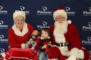 Santa and Mrs Claus with two small children