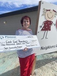 old woman holding a big check