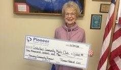 old woman holding check