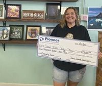 woman holding a large check
