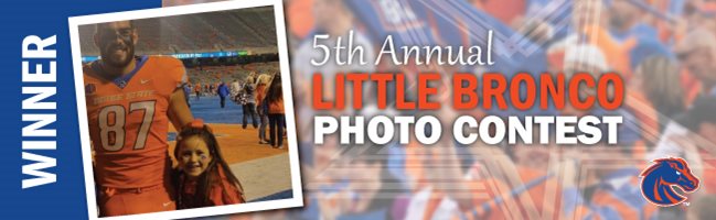 Little kid taking a photo with a Boise State football player