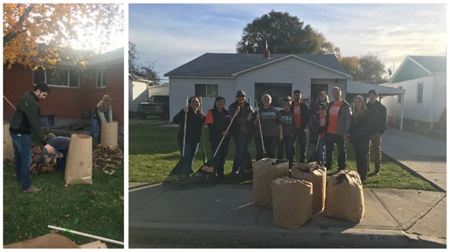 several volunteers raking up leaves in front of homes