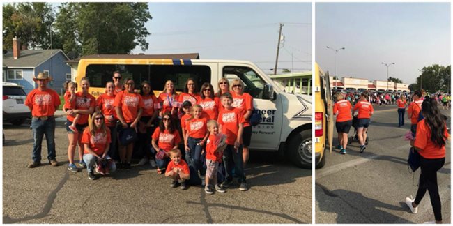 Pioneer volunteers in orange shirts participating in a parade