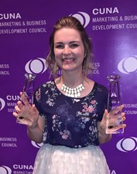 Pioneer female employee holding two crystal trophies