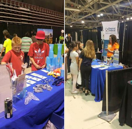 Pioneer booth at the boys and girls club, with children looking at the booth