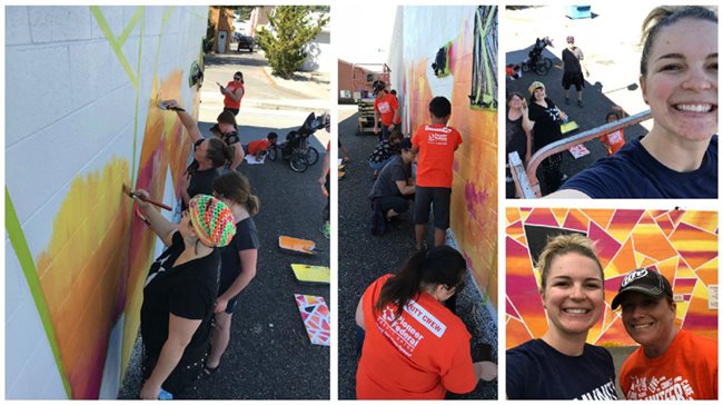 Pioneer employees painting a mural on a wall all together