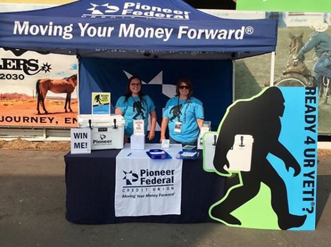 Two Pioneer employees running a booth at the rodeo