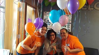 three women with balloons at an elementary school