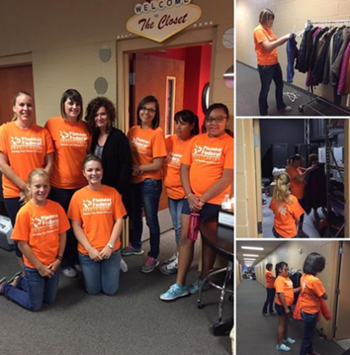 Pioneer volunteers in orange shirts working at a clothing drive charity