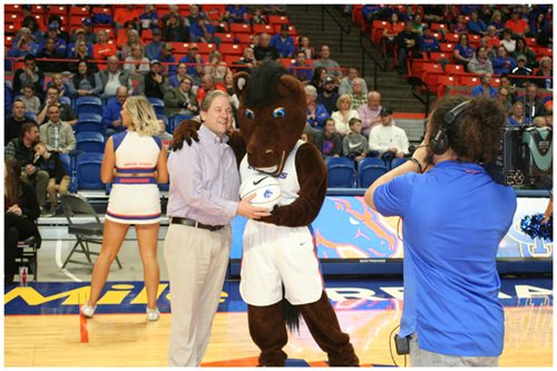 Curt Perry being handed a basketball by the BSU mascot