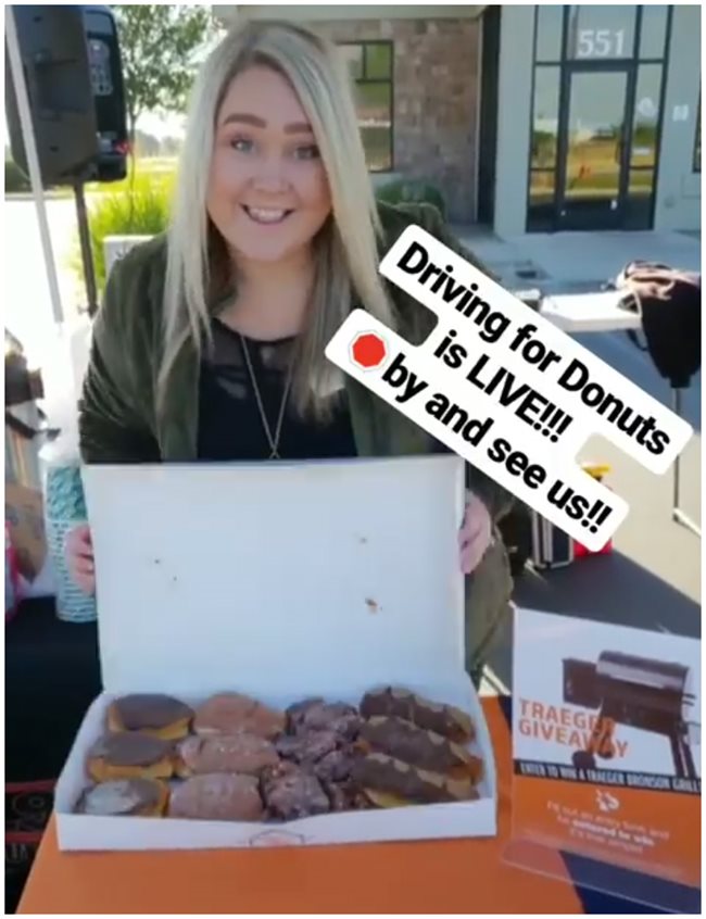 Woman holding donuts for an early morning event
