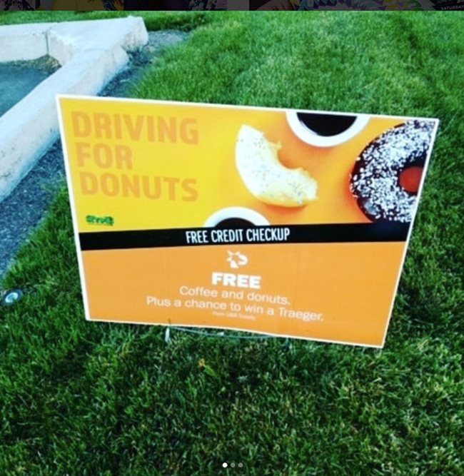 A sign advertising Driving for Donuts