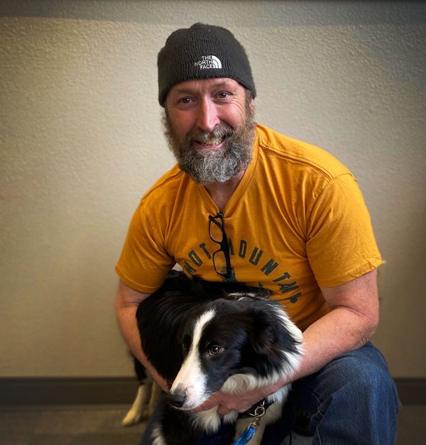 man with a beard and a dog
