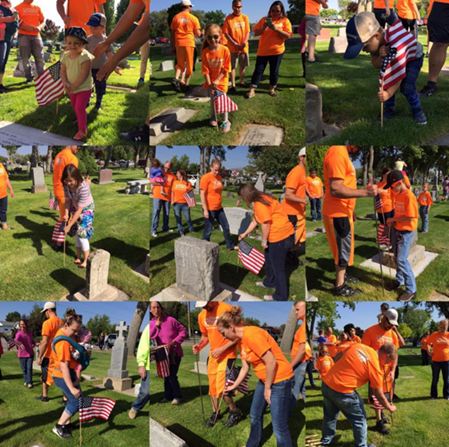 Pioneer volunteers placing US flags on graves for Memorial Day