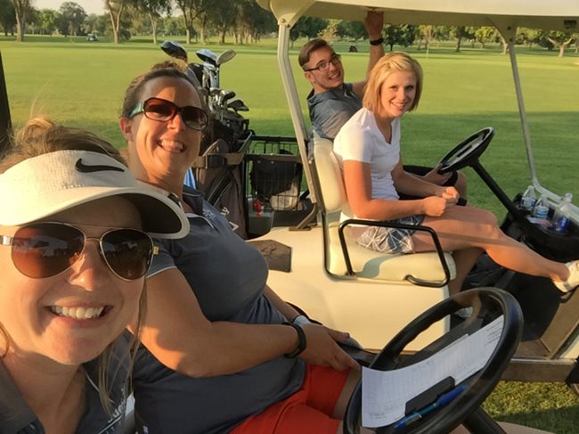 four pioneer employees enjoying an afternoon of golf and riding golf carts