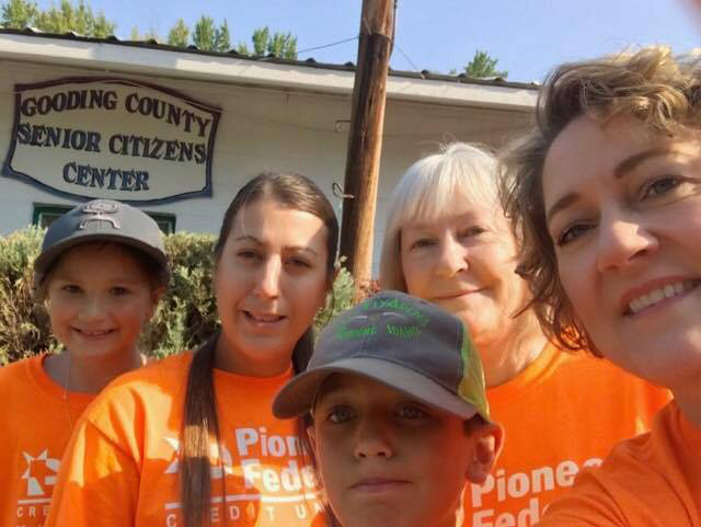 Pioneer volunteers in orange shirts outside the Gooding County Senior Citizens Center
