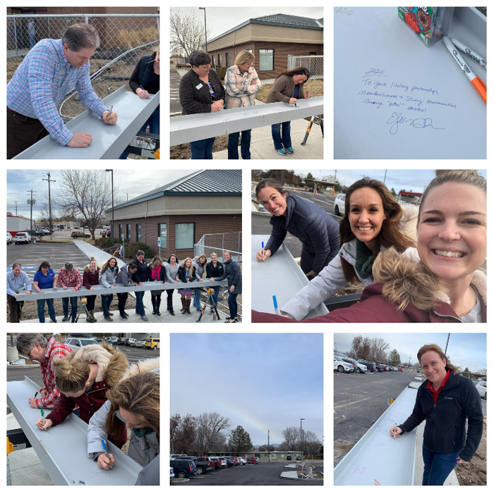 Pioneer employees signing a metal beam