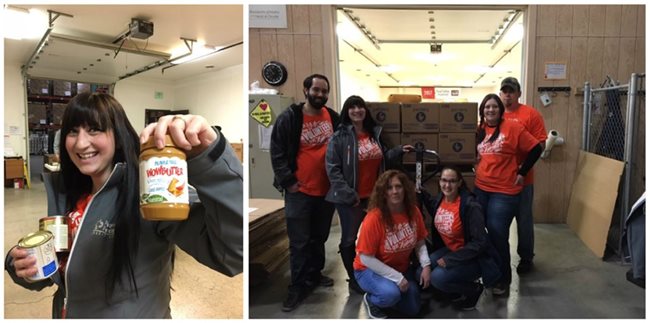 Pioneer volunteers working at the food bank, standing in front of boxes