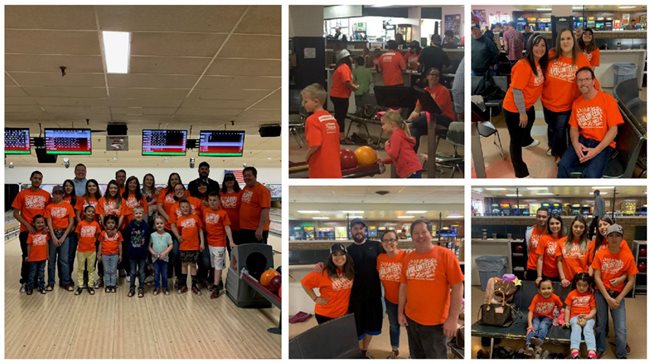Pioneer volunteers in orange shirts at a bowling alley, bowling to raise money for charity