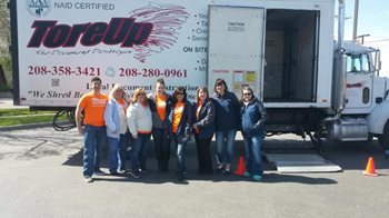A group of volunteers standing in front of a semi truck with the words "ToreUp" on the side