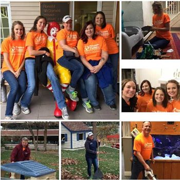 Pioneer volunteers in orange shirts cleaning and doing yard work at the Ronald McDonald house