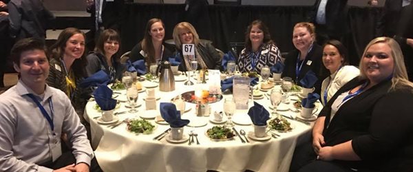 Pioneer employees sitting around a table at a nice dinner