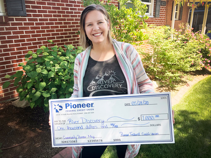 woman holding a giant check from Pioneer