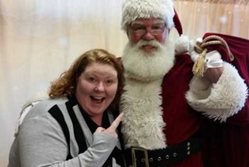 Woman posing and pointing at Santa