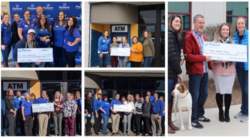 Pioneer employees presenting checks to charities