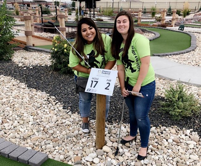 Two Pioneer employees having fun mini golfing