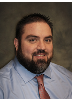 Gentleman with dark brown hair and a dark brown beard