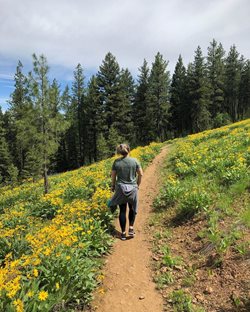 woman walking an a hiking trail