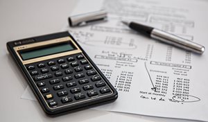 calculator and a paper with financial information