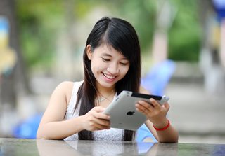 young woman looking at an iPad