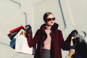fancy woman wearing sunglasses and nice clothes with a lot of shopping bags