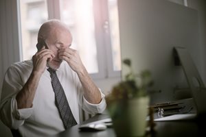 a frustrated old man on a cell phone