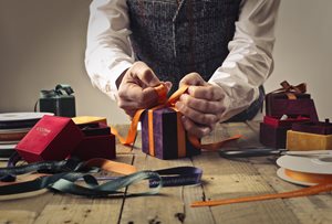 man wrapping a gift box