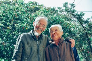 two older couple smiling at the camera