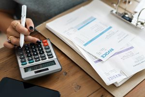 woman using a calculator to help pay bills