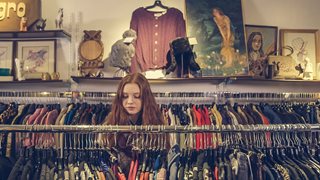 young woman clothes shopping in a boutique