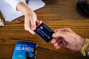 woman handing a man a credit card