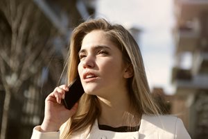 blonde woman talking on a cell phone