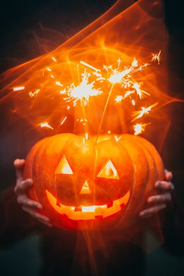 jack o lantern with sparklers sticking out of it