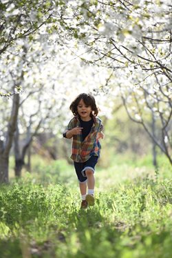 kid running through a forest