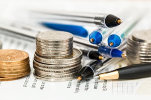 coins and pens stacked next to each other