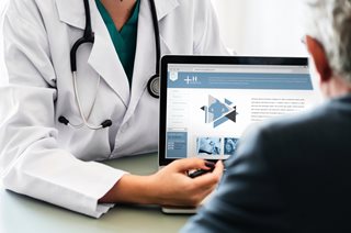 doctor showing a website to a person