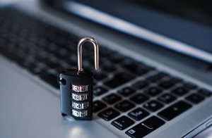 padlock sitting on top of a laptop