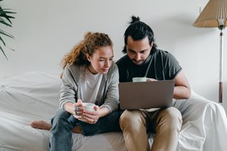 young couple looking at a laptop