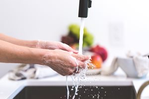 washing hands in a sink with soap
