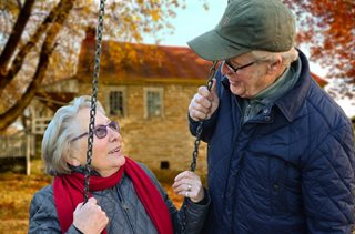 old couple talking while on a swing